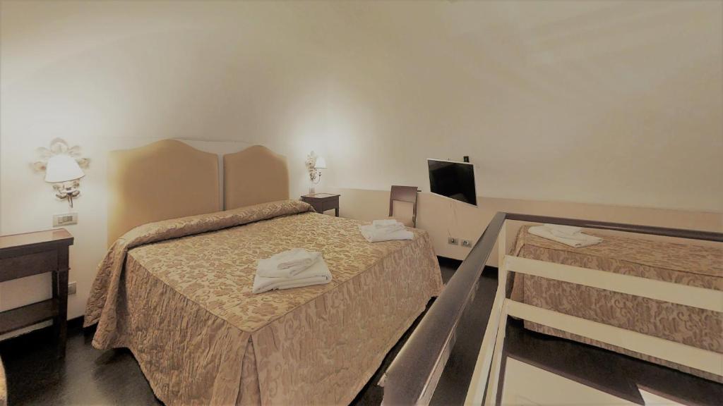 Postel nebo postele na pokoji v ubytování Hotel Lanzillotta