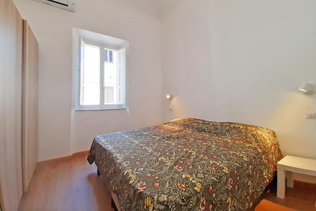 a bedroom with a bed in a room with a window at Casa Brezza marina in Marina di Campo
