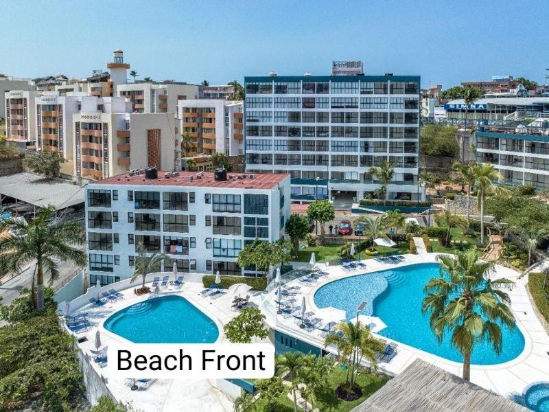 an aerial view of a beachfront resort with two pools at Departamento en Condominio Astoria in Acapulco
