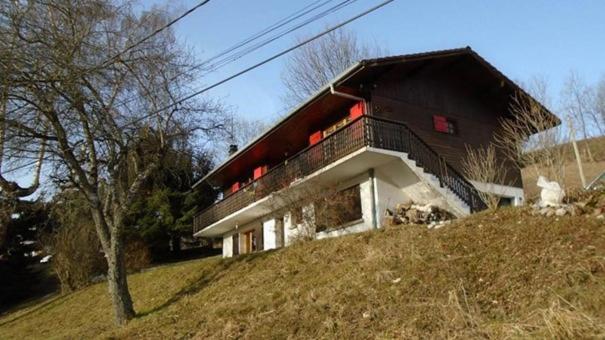 a house sitting on top of a hill at Bernex(74) Appartement 4 personnes dans chalet vue imprenable in Bernex