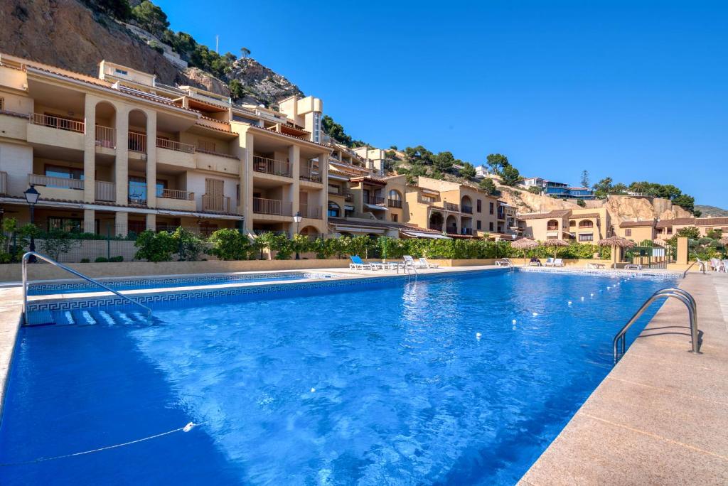 a large swimming pool in front of a building at Blue Greenwich Port in Altea