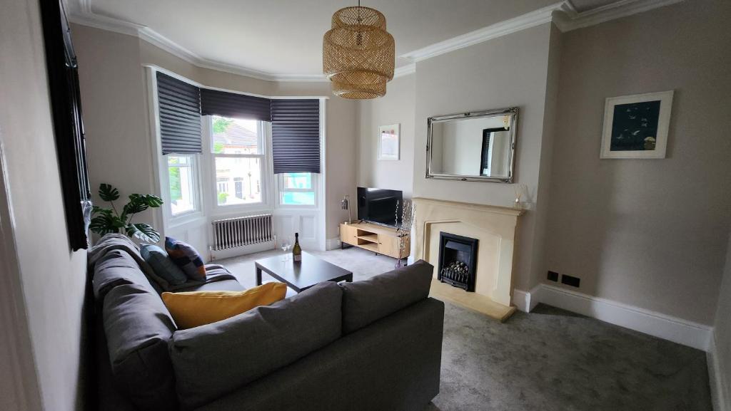 a living room with a couch and a fireplace at Contemporary beach apartment in Brighton & Hove