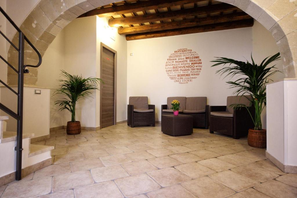 a waiting room with chairs and plants in a building at Duci Duci Appartamenti in Trapani