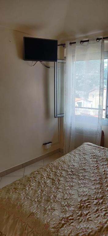 a bedroom with a large bed and a window at Dolce Vita Alta Ventimiglia in Ventimiglia