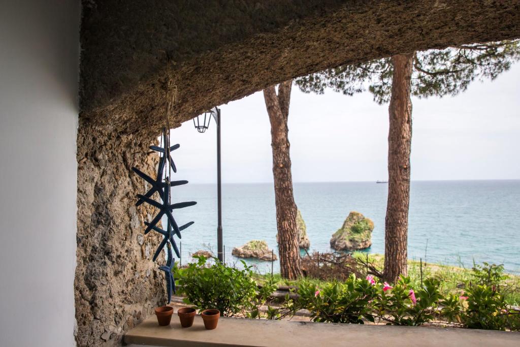 a window with a view of the ocean at Luxurious apartment by the sea in Vietri sul Mare