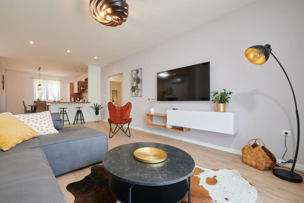 a living room with a couch and a table at Apartman Babalui in Trogir