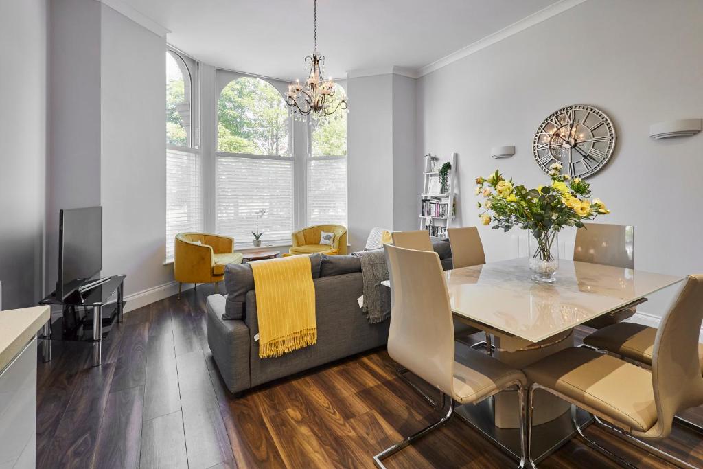 a dining room and living room with a table and a couch at Host & Stay - Brooklands Timeless in Scarborough