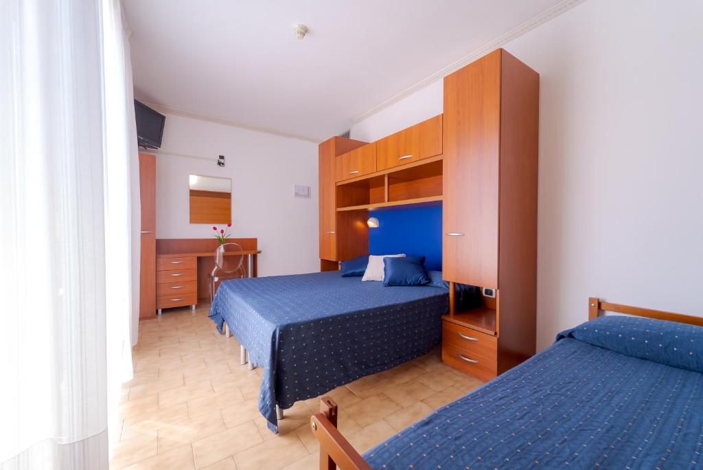 Postel nebo postele na pokoji v ubytování Hotel Beach