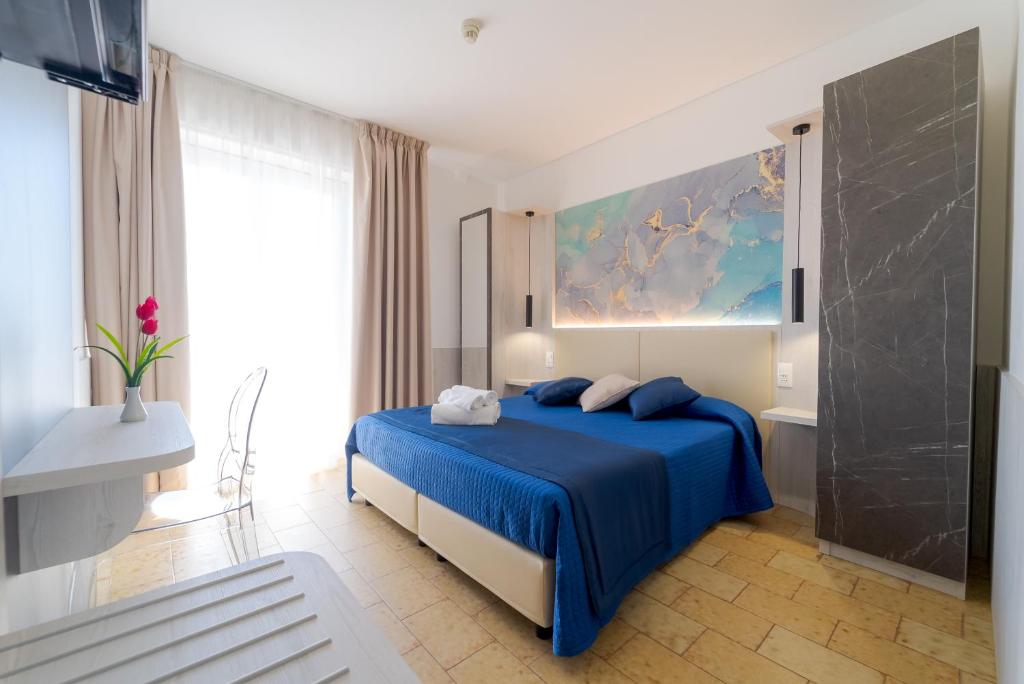 Postel nebo postele na pokoji v ubytování Hotel Beach