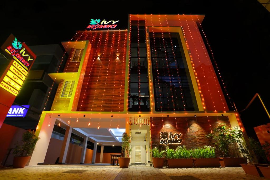 a hotel building with lights on it at night at IVY RESIDENCY in Trivandrum