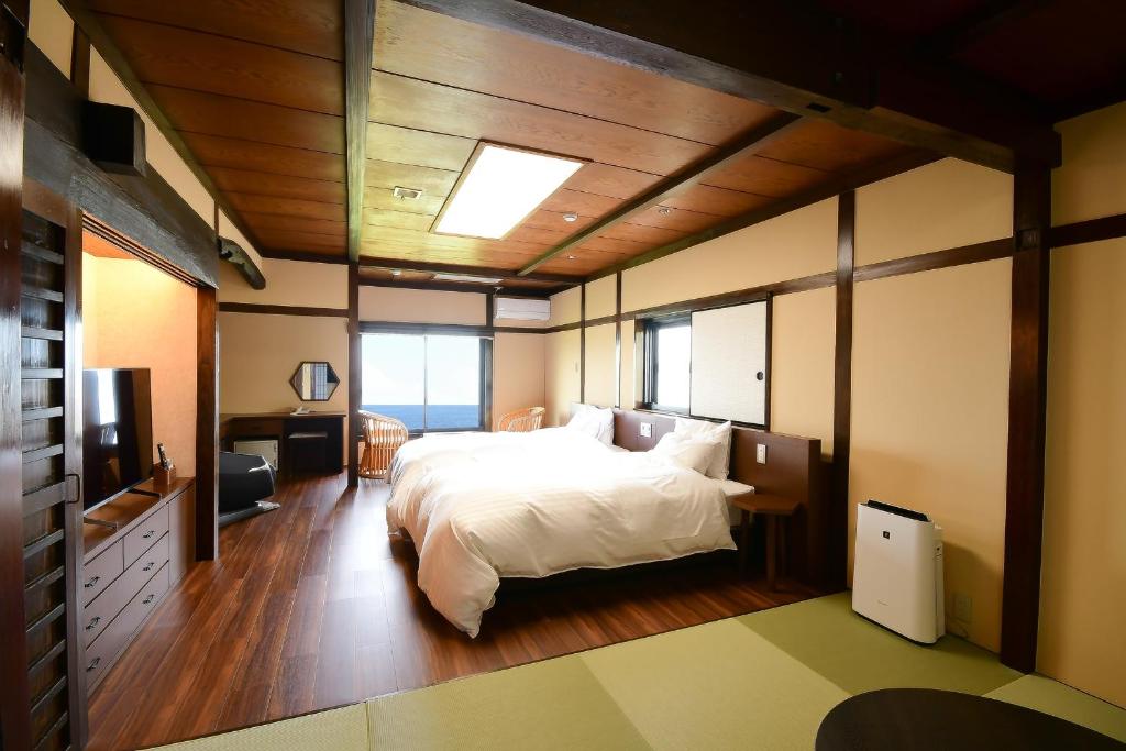 Postel nebo postele na pokoji v ubytování 黒潮の宿 臨海荘 -Kuroshio no yado Rinkaisou-