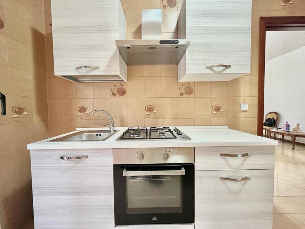 a kitchen with a sink and a stove at La casetta di Alice in Palermo