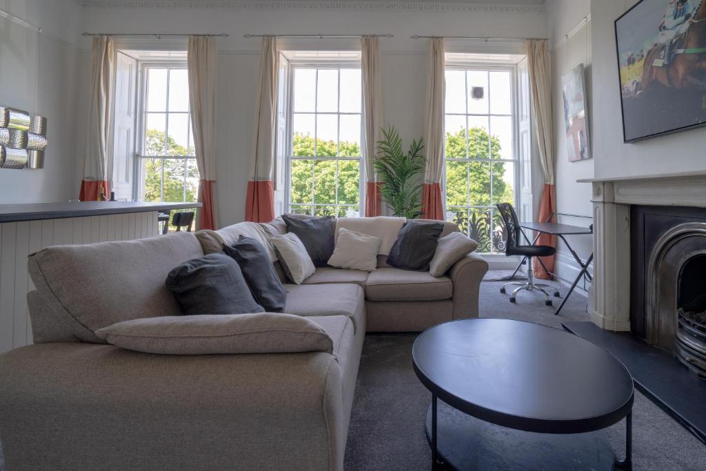 uma sala de estar com um sofá e uma lareira em Montpellier Regency apartment balcony & parking em Cheltenham