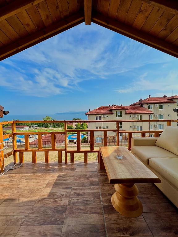 a patio with a couch and a table on a balcony at Seagull Studio Byala in Byala