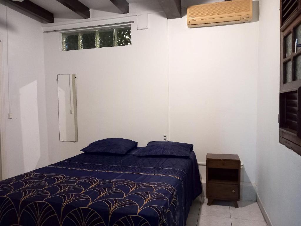 a bedroom with a blue bed and a window at Appartement d&#39;une chambre avec balcon et wifi a Le Vauclin a 3 km de la plage in Le Vauclin