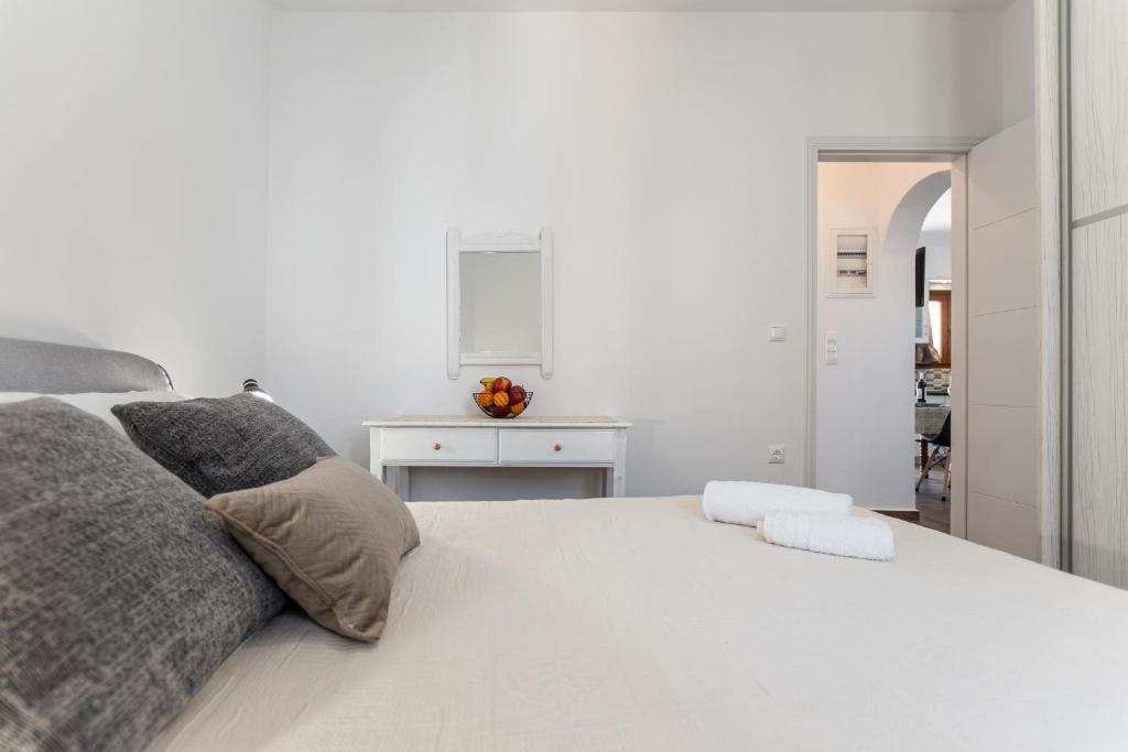 a white bedroom with a large white bed at Naxian White House In Glinado in Glinado Naxos