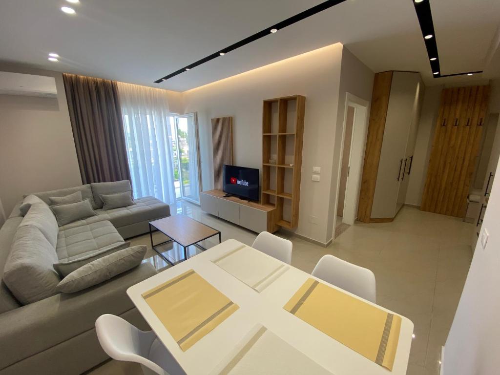 Olivia's Apartments في فيليبوجي: غرفة معيشة مع أريكة وطاولة
