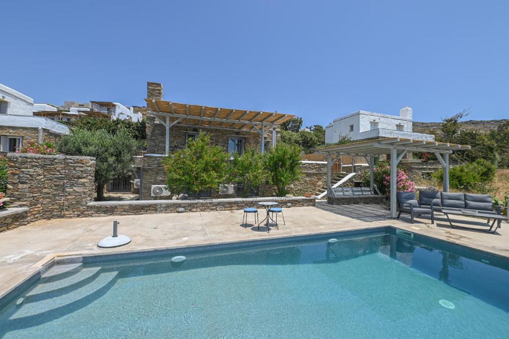 a swimming pool in front of a house at Dream summer house in Tinos in Tinos Town