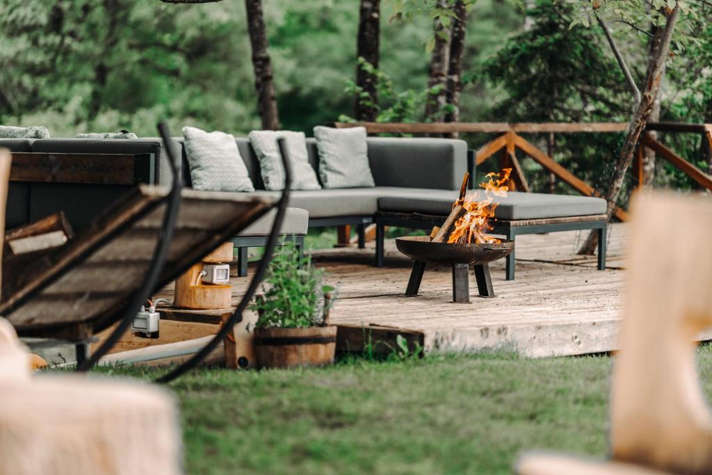 a firepit with couches and a fire pit with a fire pit at Goat's Paradise in Bohinj