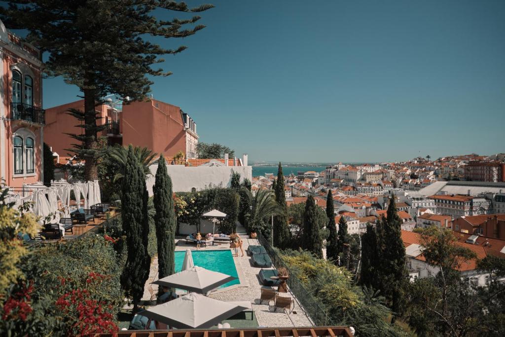 a view of a resort with a pool and trees at Torel Palace Lisbon in Lisbon