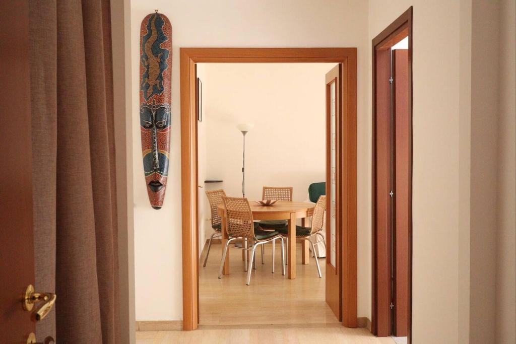 een kamer met een tafel en een surfplank aan de muur bij Casa Etruschi - Appartamento con posto auto in Livorno