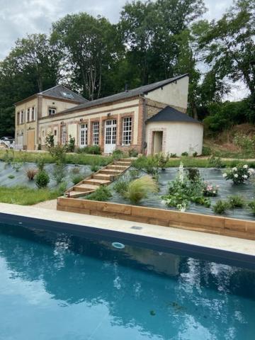 a house with a swimming pool in front of it at maison 8 pers avec piscine en pleine nature in Ambenay