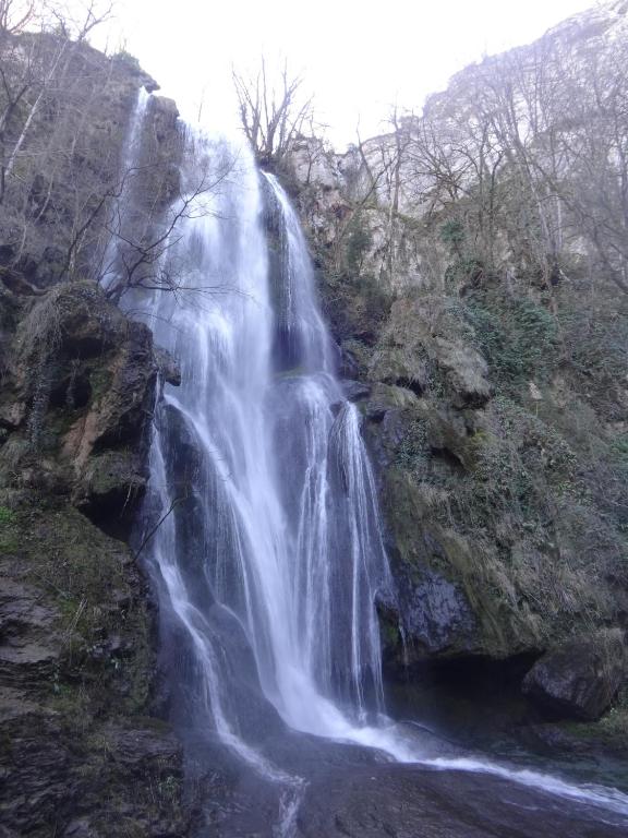 a waterfall on the side of a mountain at Gîte "le haut des Poujades" in Reilhaguet