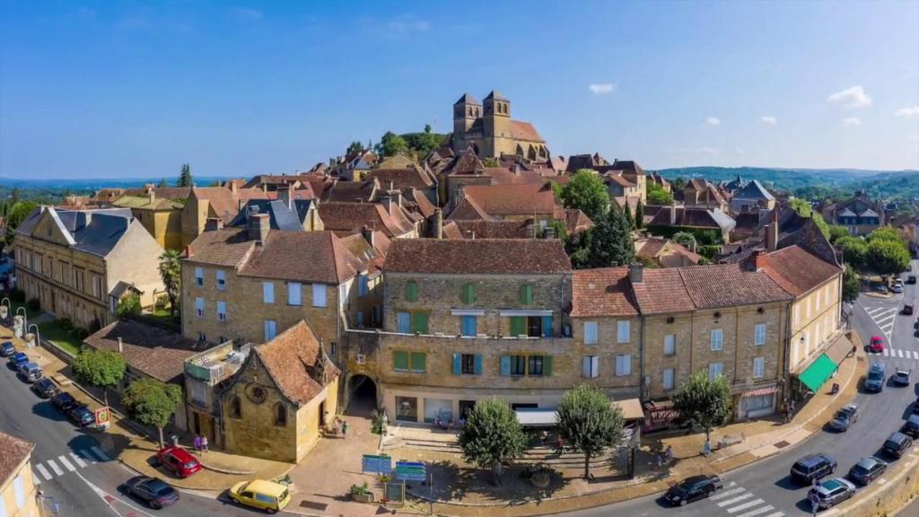 an old town with a castle on top of it at Gîte "le haut des Poujades" in Reilhaguet