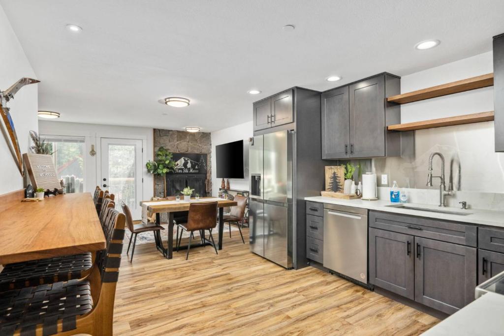 a kitchen with stainless steel appliances and a wooden floor at Nor Ski Haus B in Government Camp