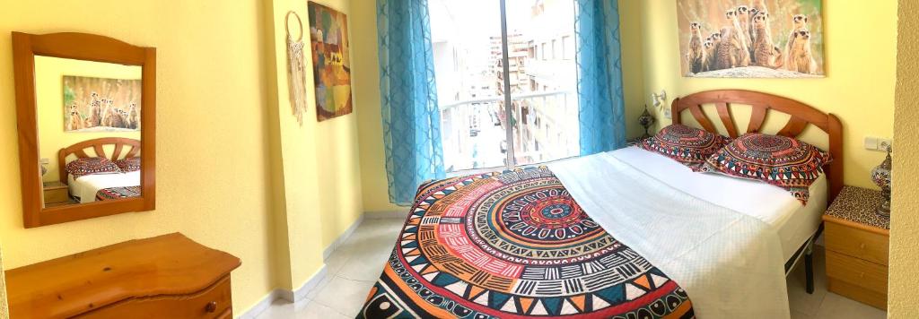 a bedroom with a bed and a window at ApartalMar in Torrevieja