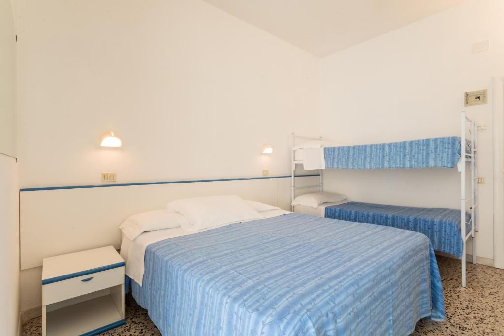 Postel nebo postele na pokoji v ubytování Hotel Leon D'oro