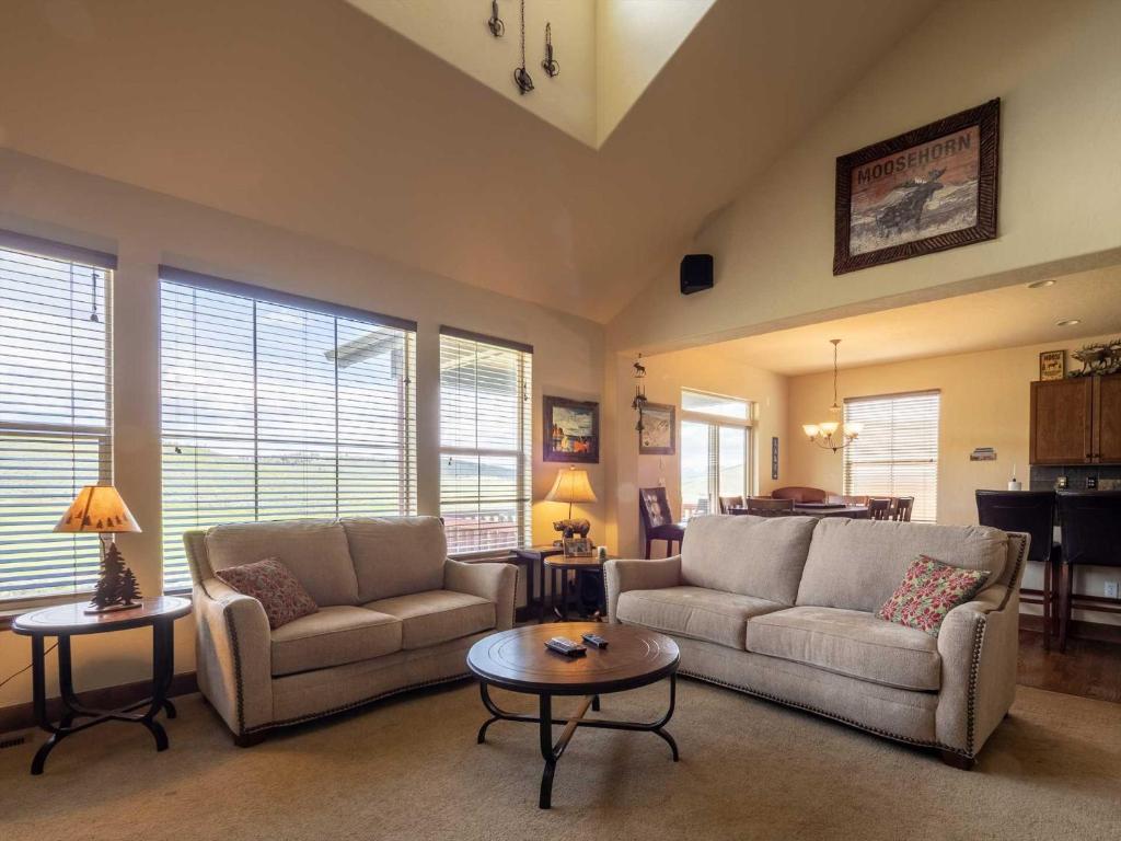 a living room with two couches and a table at Fairview 2 in Granby