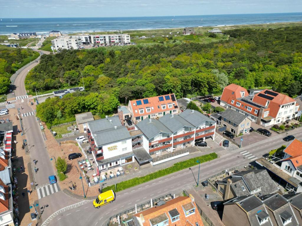 an aerial view of a town with a road and houses at Motel Texel in De Koog