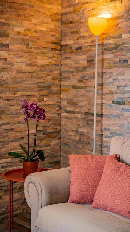 a living room with a couch and a table with a flower at Apartments Edera in Tivat
