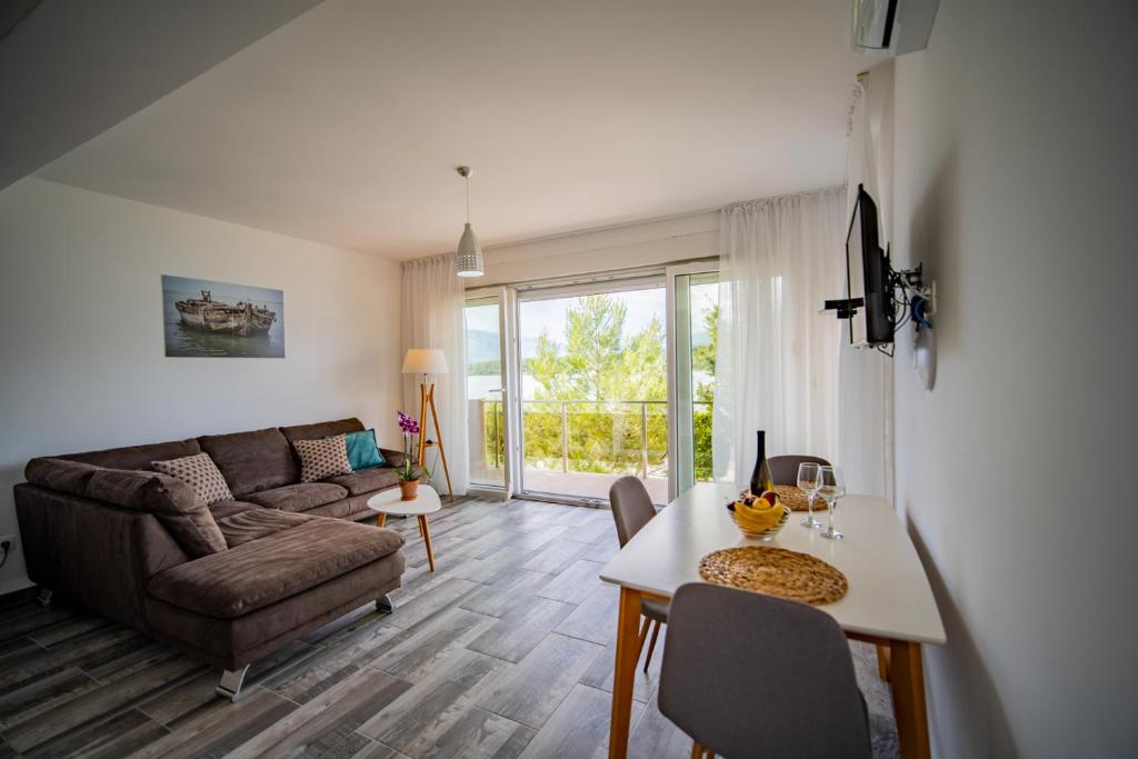 a living room with a couch and a table at Apartments Edera in Tivat