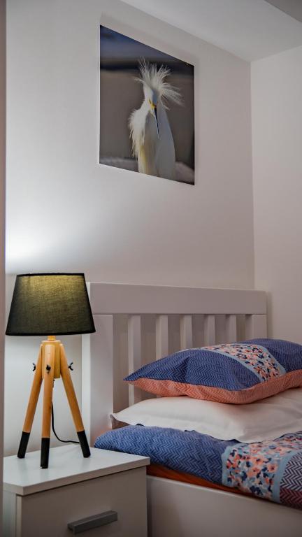 a bedroom with a bed and a table with a lamp at Apartments Edera in Tivat