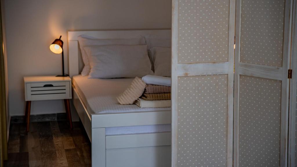 a small bedroom with a bed and a night stand at Apartments Edera in Tivat
