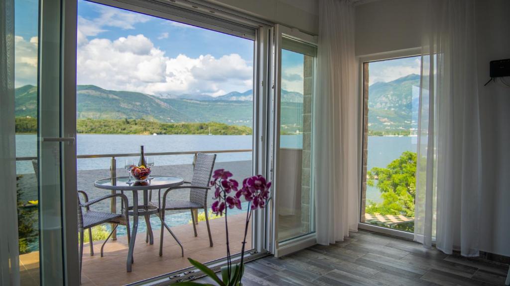 a balcony with a table and a view of a lake at Apartments Edera in Tivat