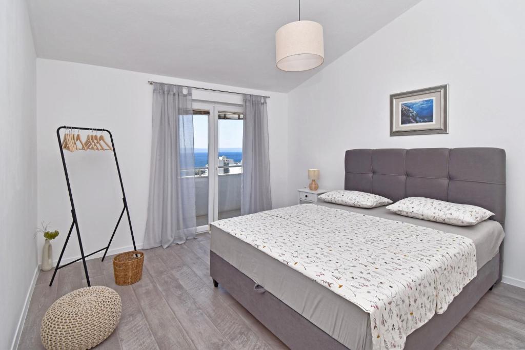 une chambre avec un lit et une vue sur l'océan dans l'établissement Sunny room, à Tučepi