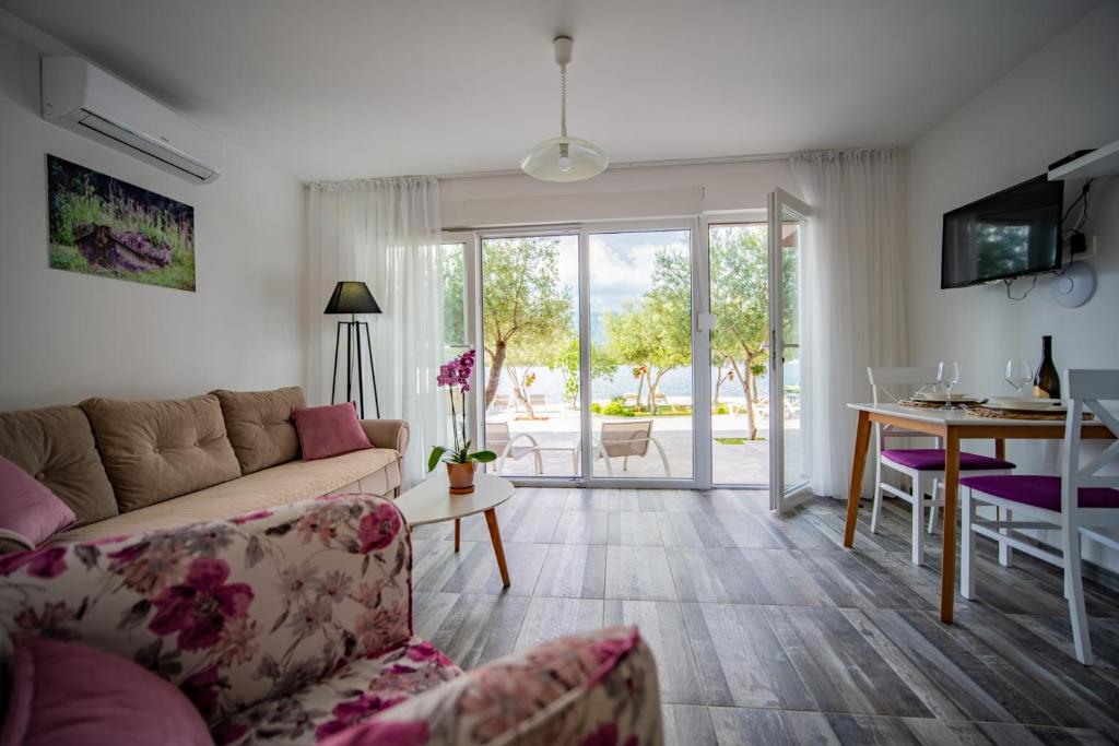 a living room with a couch and a table at Apartments Edera in Tivat