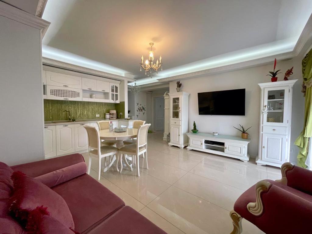 ein Wohnzimmer mit einem roten Sofa und einem Tisch in der Unterkunft Lux apartament in Focşani