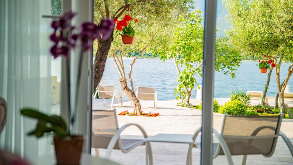 a porch with chairs and a view of the water at Apartments Edera in Tivat
