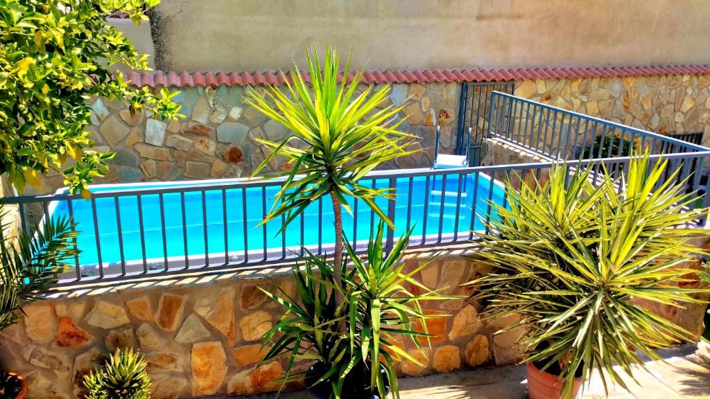 una piscina en una pared de piedra con plantas en Casa Rural Los Mayorales, en Esparragalejo