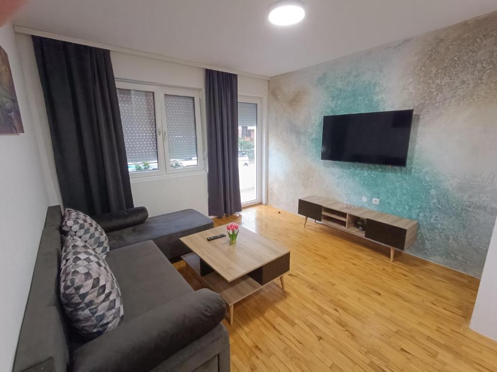 a living room with a couch and a flat screen tv at Finesi apartments 3 in Ohrid