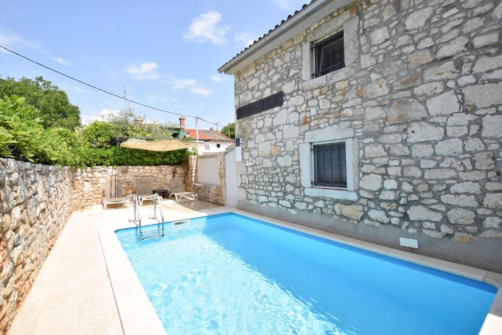 a house with a swimming pool next to a building at Luxury Casa Nini w fireplace and private pool in Poreč
