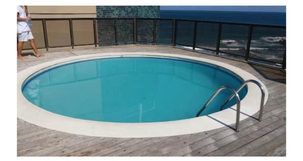 a swimming pool on the deck of a building at Apartamento inteiro frente ao mar de ondina in Salvador