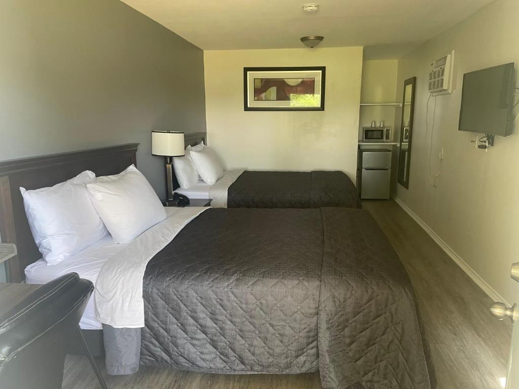 Postel nebo postele na pokoji v ubytování Nites Inn Motel