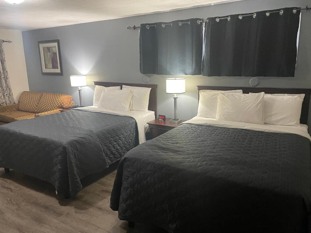 Postel nebo postele na pokoji v ubytování Nites Inn Motel