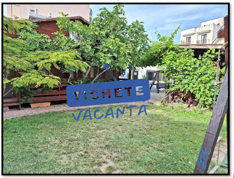 a sign for a hotel xantania in a yard at Casa Cris Will in Mamaia Nord