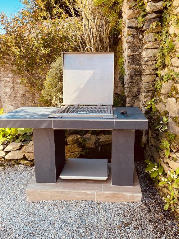 a laptop computer sitting on top of a wooden desk at Sur le chemin de la plage in Cherbourg en Cotentin